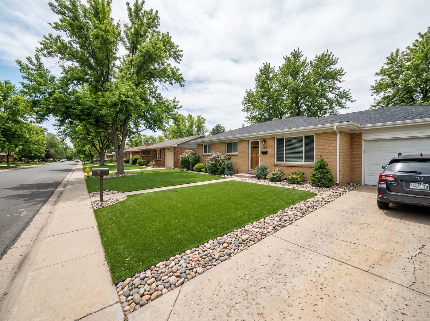 Denver backyard artificial turf installation with fire pit patio area